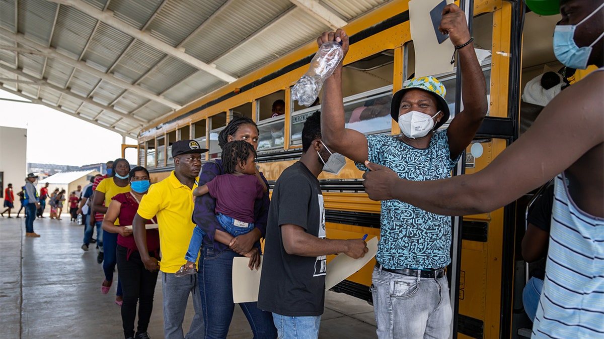 Haitian migrants load onto buses in Texas