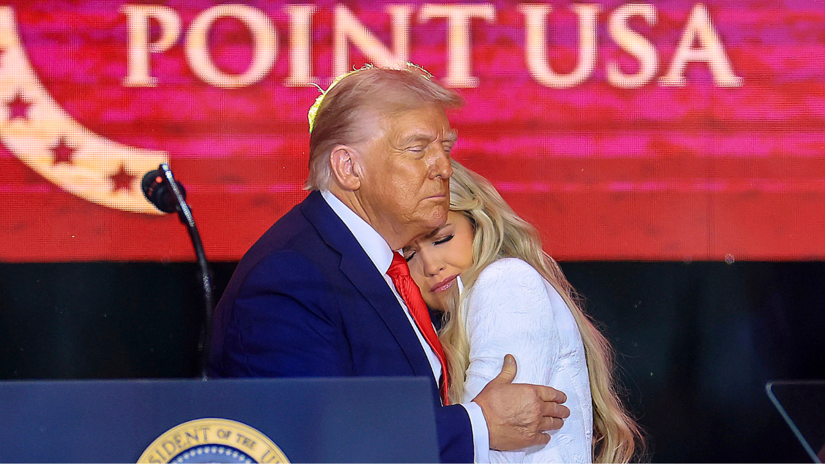 President Donald Trump hugs Erika Kirk