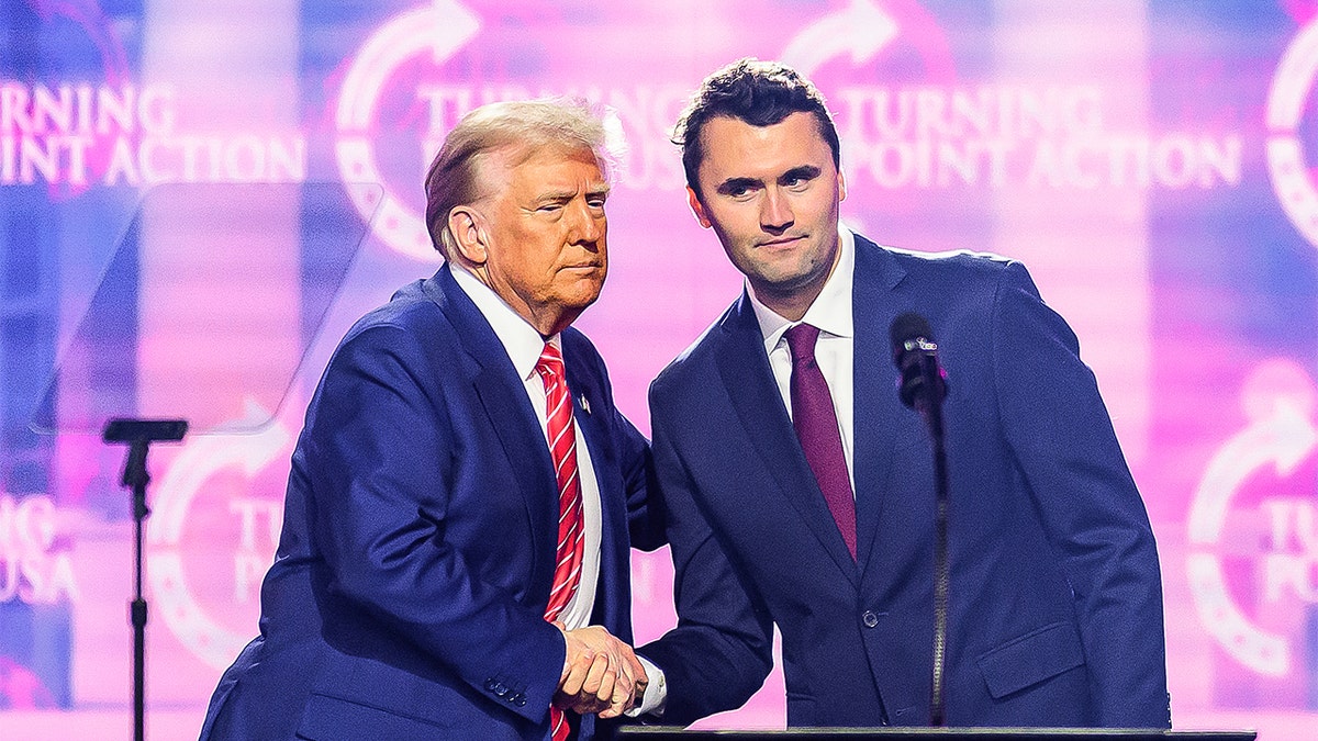 Charlie Kirk shakes hands with President Donald Trump