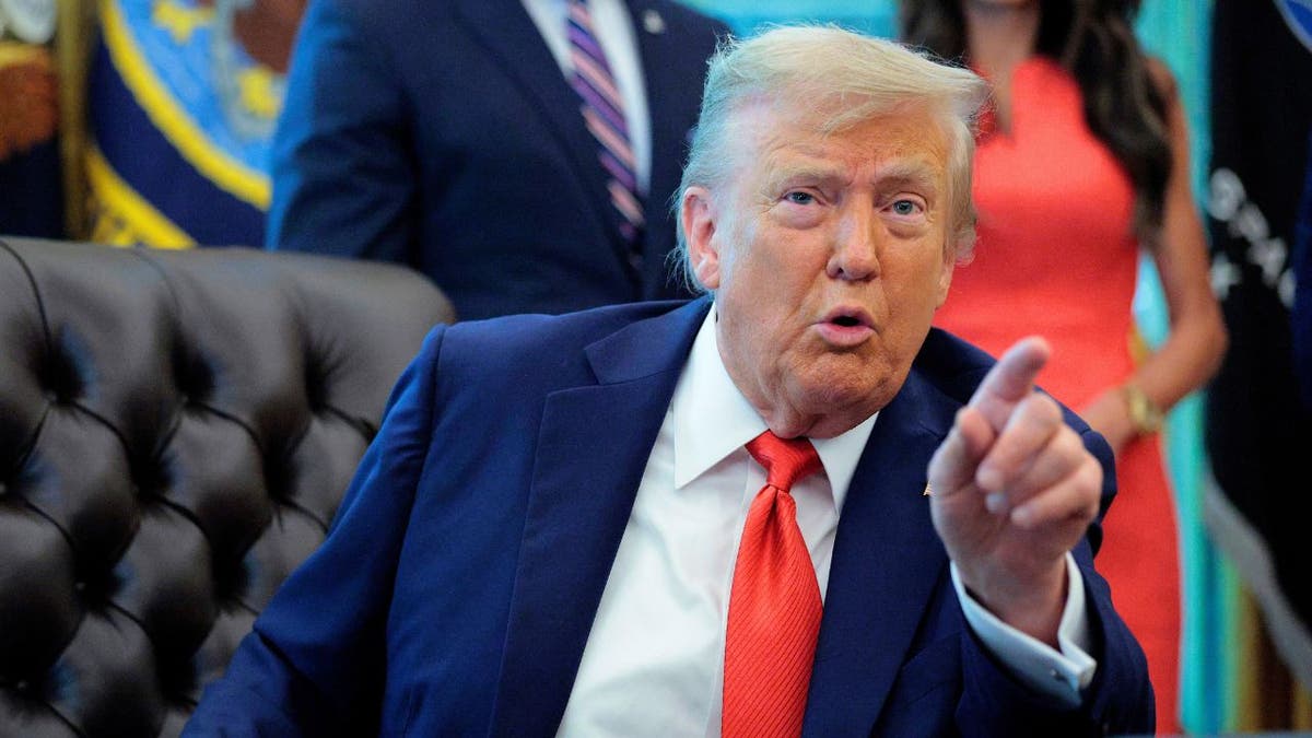 President Donald Trump points while speaking in the Oval Office