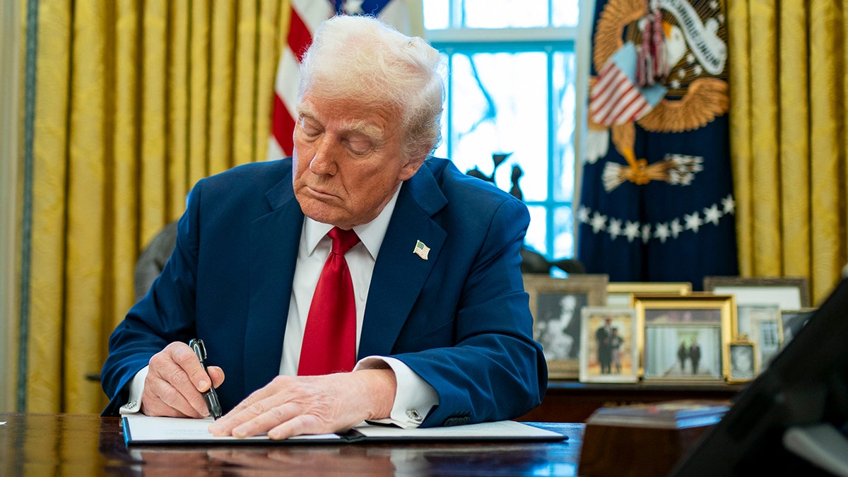 President Donald Trump signs an executive order