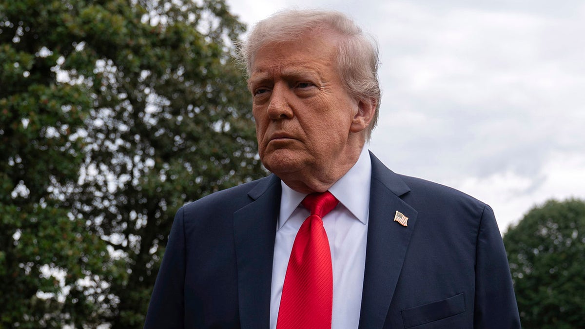 President Donald Trump talks to reporters