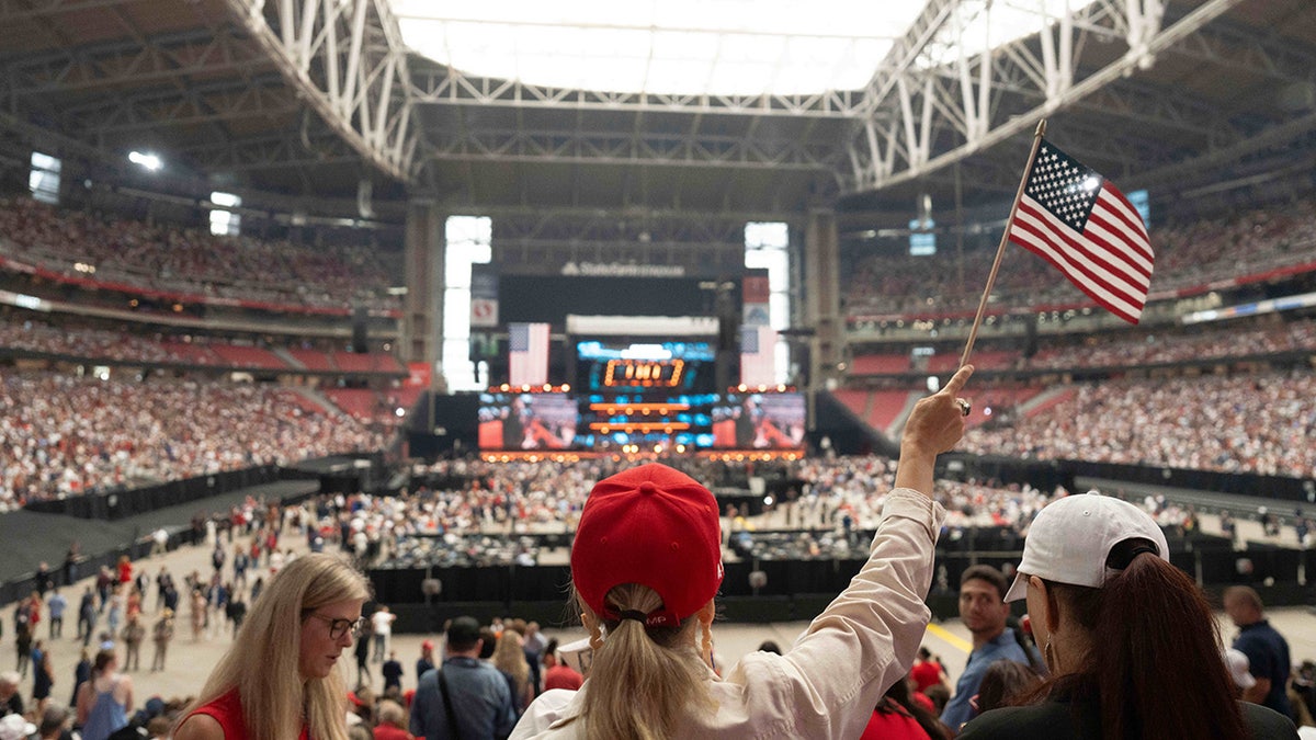Mourner waves a flag at Charlie Kirk Memorial Service
