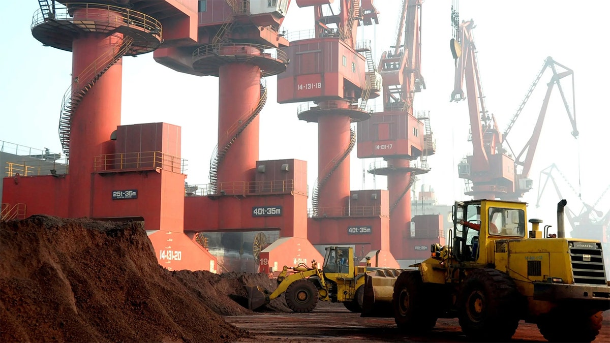 Workers transport soil containing rare earth elements for export at a port in Lianyungang, Jiangsu province, China