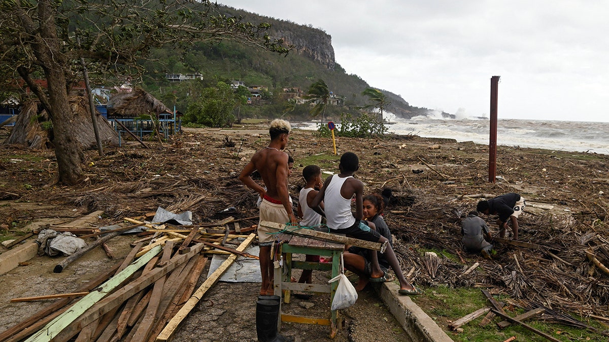 People stand on beach following impacts of Hurricane Melissa in Cuba