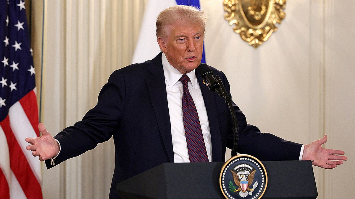 President Donald Trump speaks at a podium.