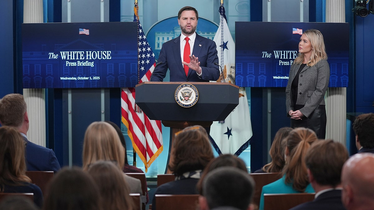 JD Vance speaks as Karoline Leavitt listens during White House press briefing