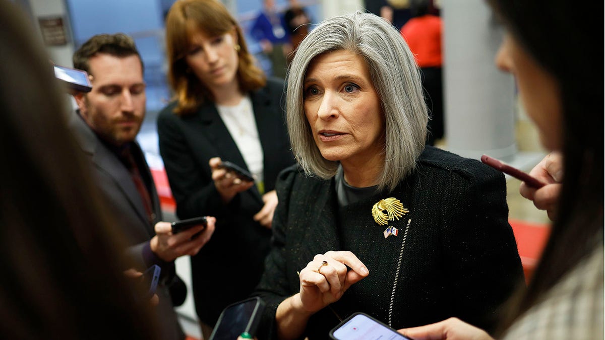 Sen. Joni Ernst R-Iowa, speaks to reporters in the Senate subway