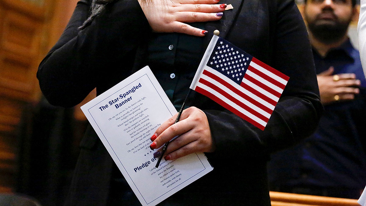 A legal migrant swears in to become a U.S. citizen at a naturalization ceremony.