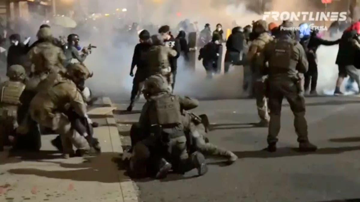 Federal agents arrest a person outside an Immigration and Customs Enforcement (ICE) facility in Portland, Oregon, on June 18, 2025.