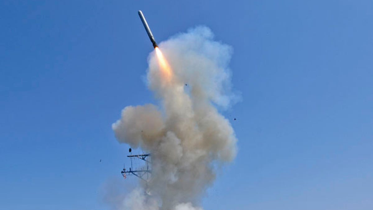 The guided-missile destroyer USS Barry launches a Tomahawk cruise missile from the ship's bow 