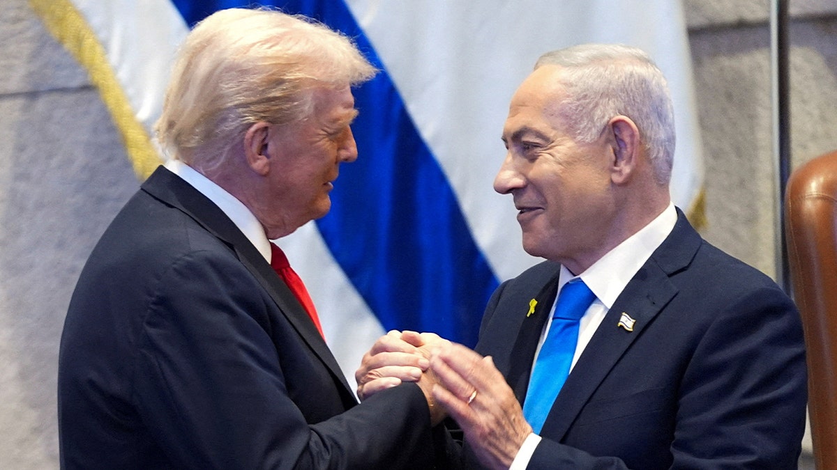 President Donald Trump talks with Israel's Prime Minister Benjamin Netanyahu at the Knesset, Monday, Oct. 13, 2025, in Jerusalem.