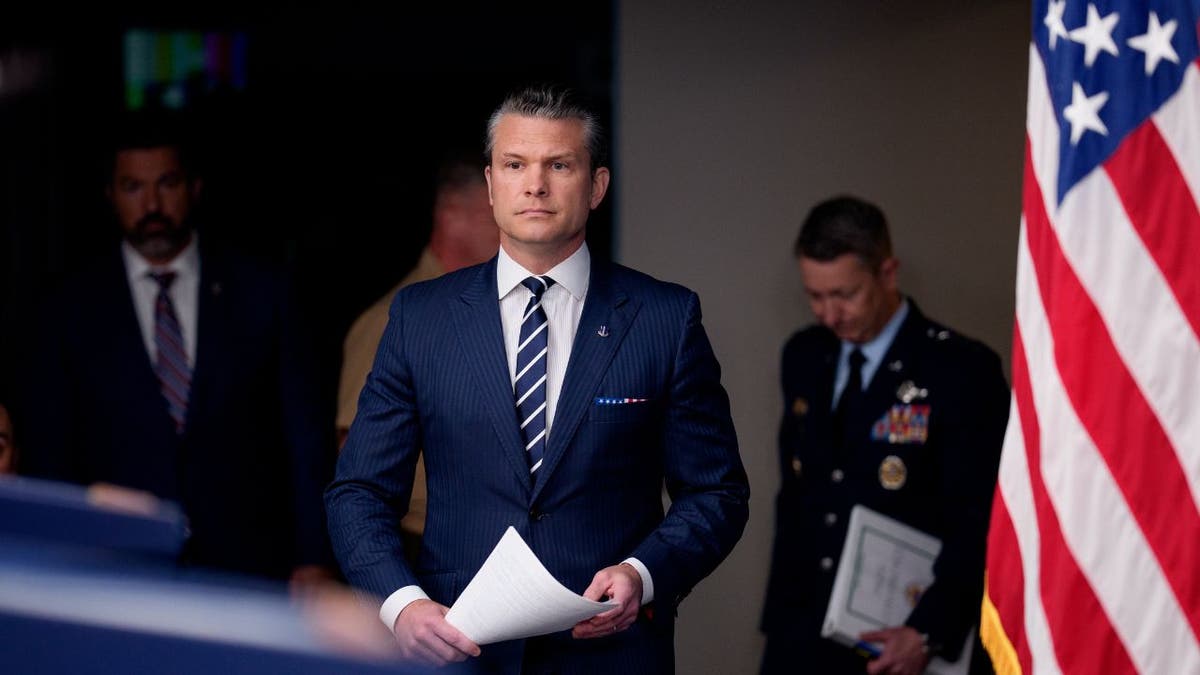 Defense Secretary Pete Hegseth arrives at a Pentagon briefing.