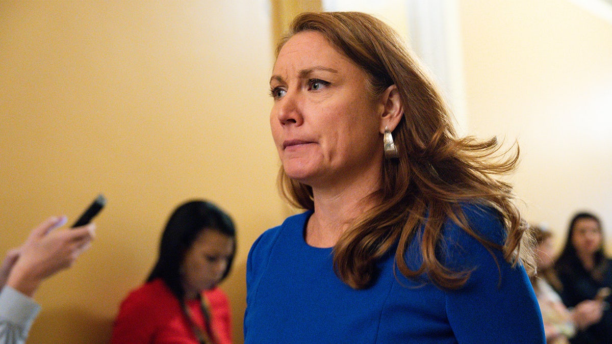 Congresswoman Melanie Stansbury walks through a hallway