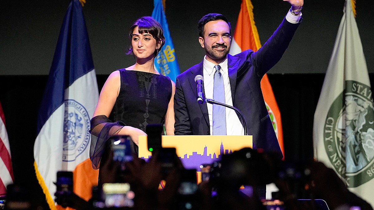 Zohran Mamdani and his wife on stage.