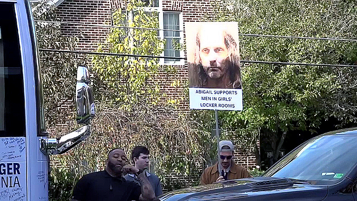 Protester with Richard Cox sign