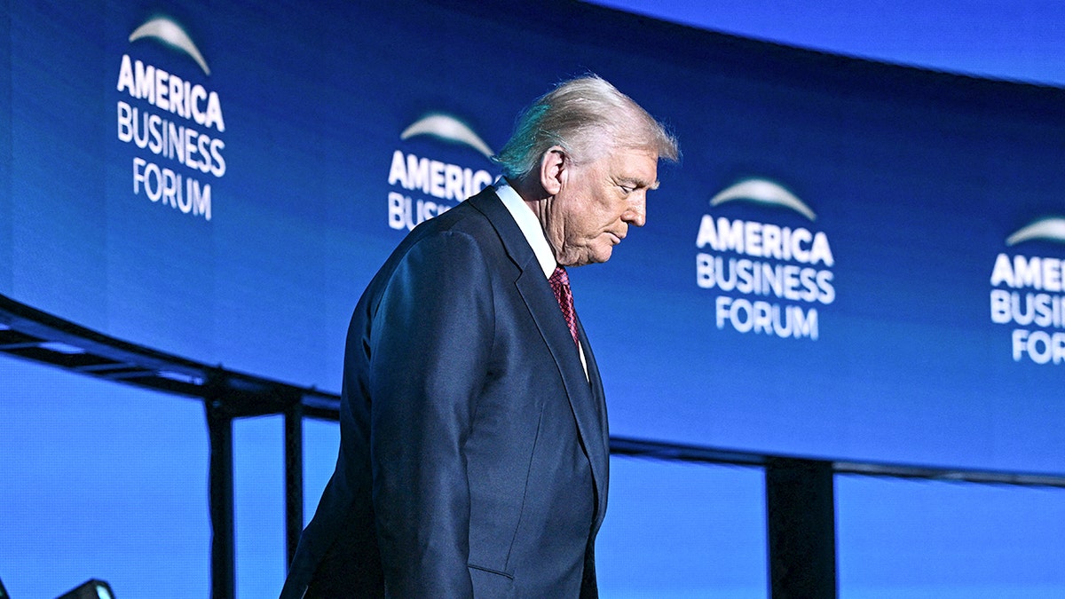 Trump walking with his head down