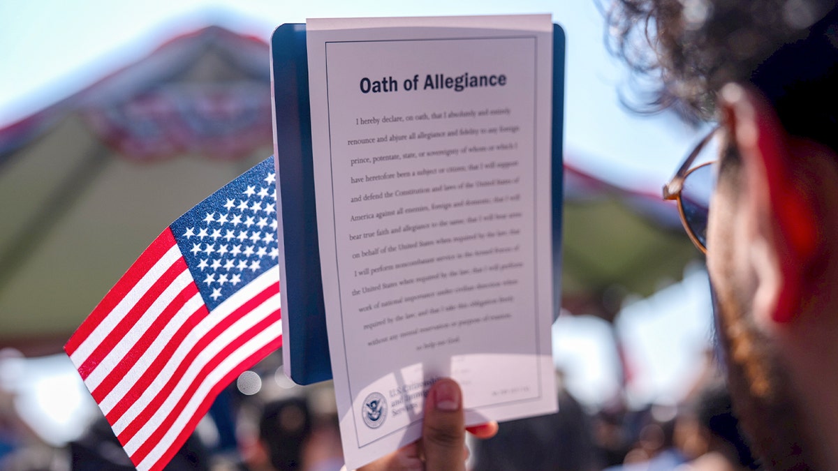 New citizen holding flag.
