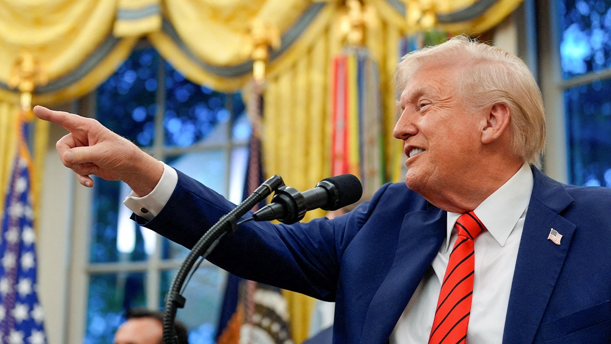 Trump smiles and points