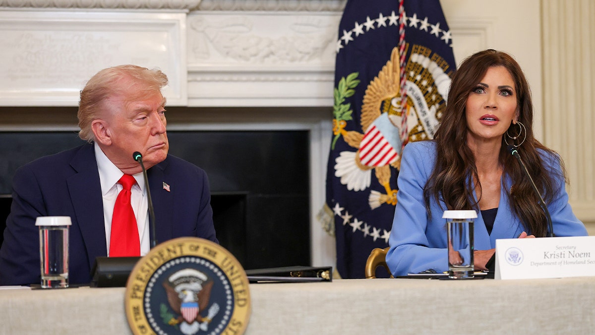 Trump and Noem seated at a table