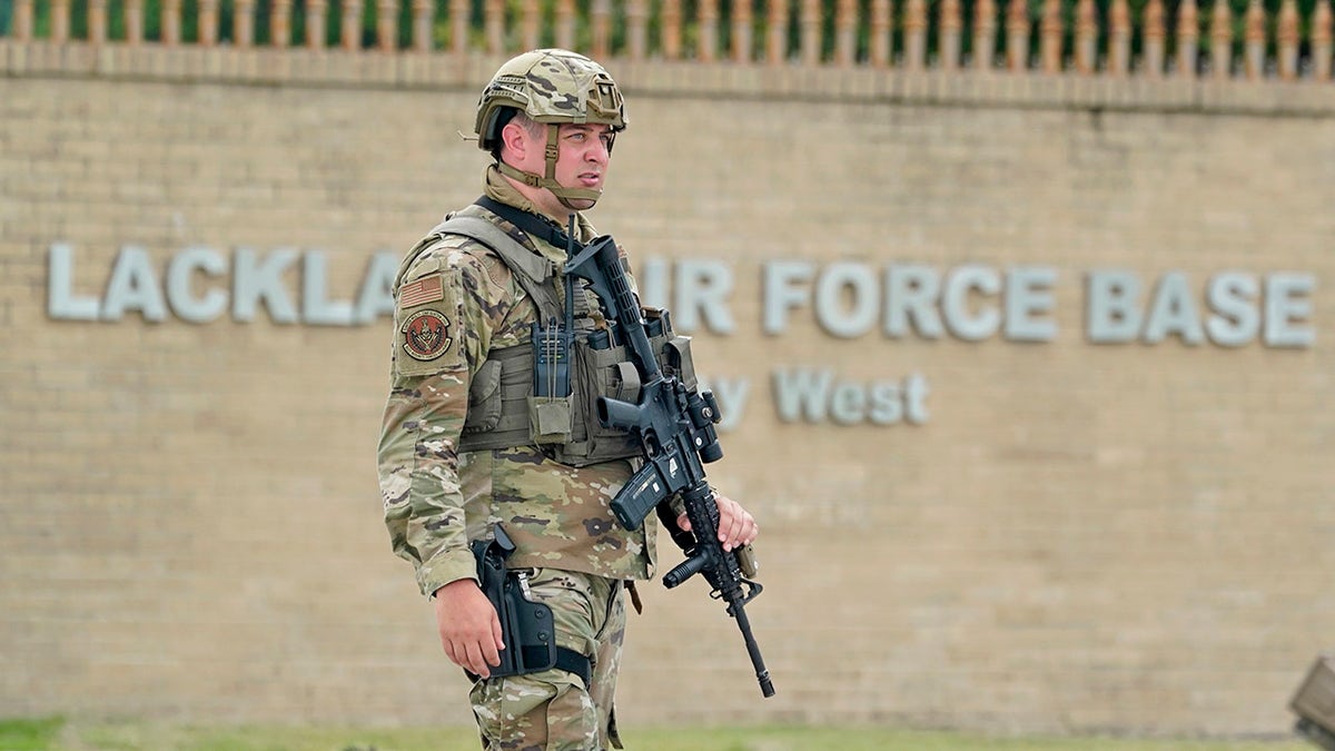 A military policeman stands guard at JBSA-Lackland Air Force Base game, Wednesday, June 9, 2021, in San Antonio. The Air Force was put on lockdown as police and military officials say they searched for two people suspected of shooting into the base from outside. 