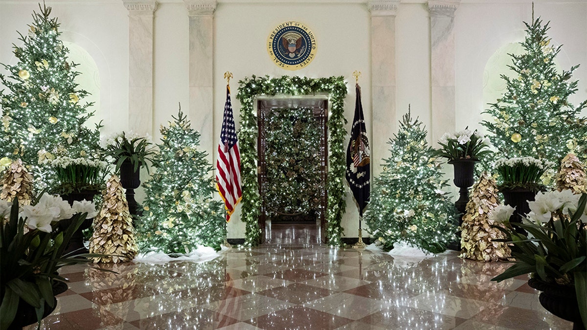 The official White House Christmas tree is decorated in the Blue Room, seen through the Cross Hall, during the 2019 Christmas preview at the White House, Monday, Dec. 2, 2019, in Washington. 