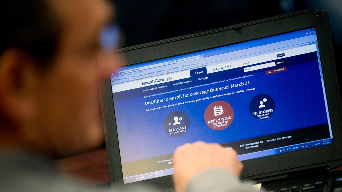 Man at laptop views the HeathCare.gov website
