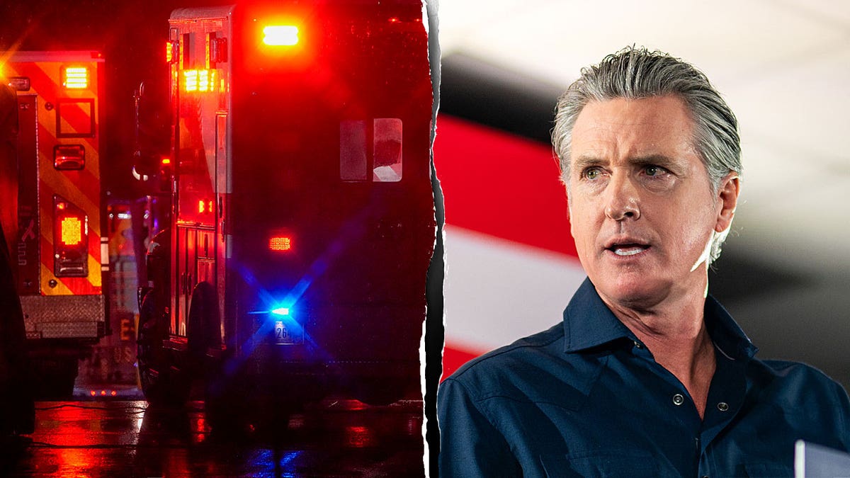 California governor Gavin Newsom next to ambulance lights.