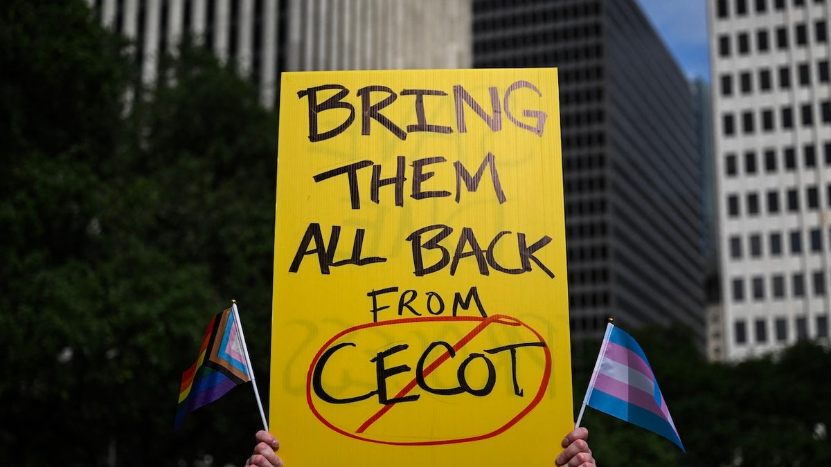 A person holds up a sign referencing the Centre for Terrorism Confinement (CECOT) prison in El Salvador during a May Day demonstration against President Donald Trump and his immigration policies in Houston, Texas, on May 1, 2025. 