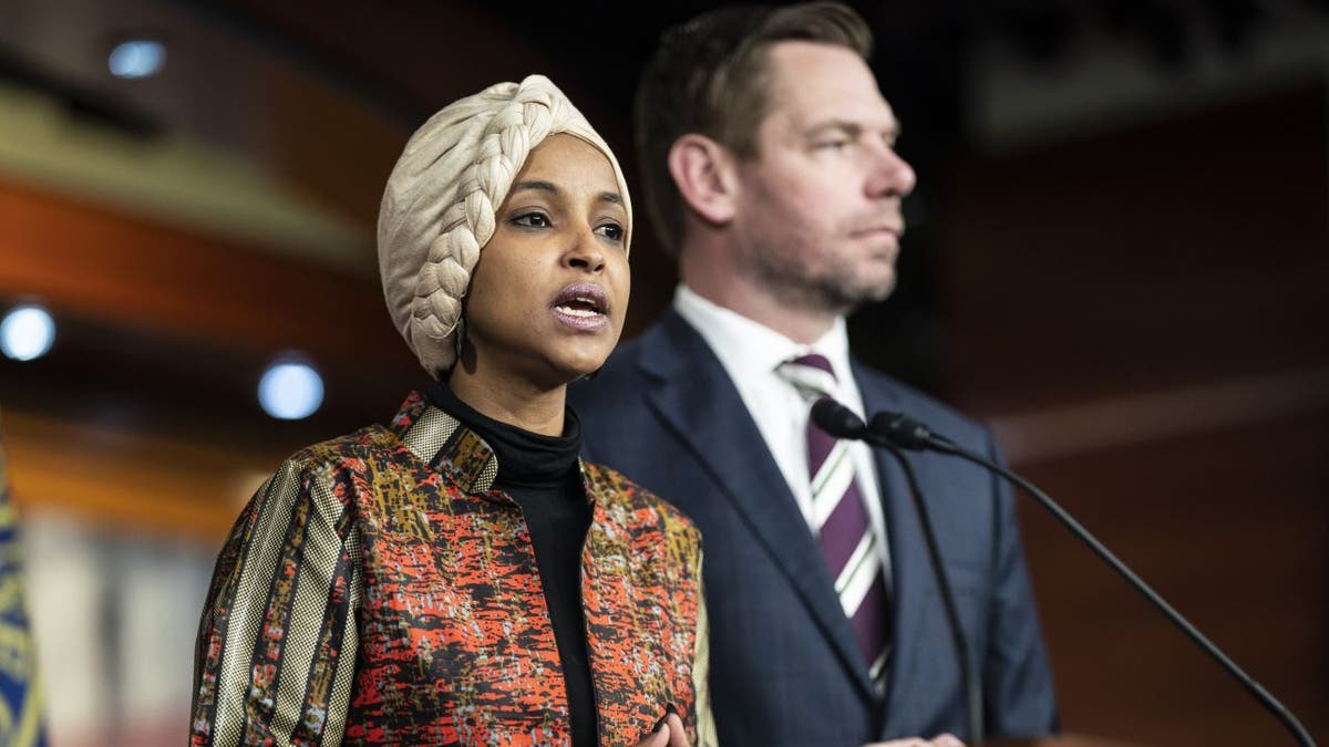 Ilhan Omar stands with Eric Swalwell.