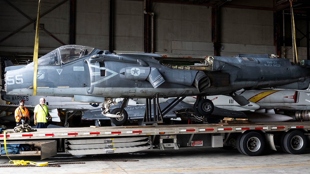 An AV-8B Harrier is moved into a hangar near the future location of the Flying Leatherneck Aviation Museum in Irvine, CA on Friday, March 14, 2025. The aircraft arrived in several parts and will be restored.