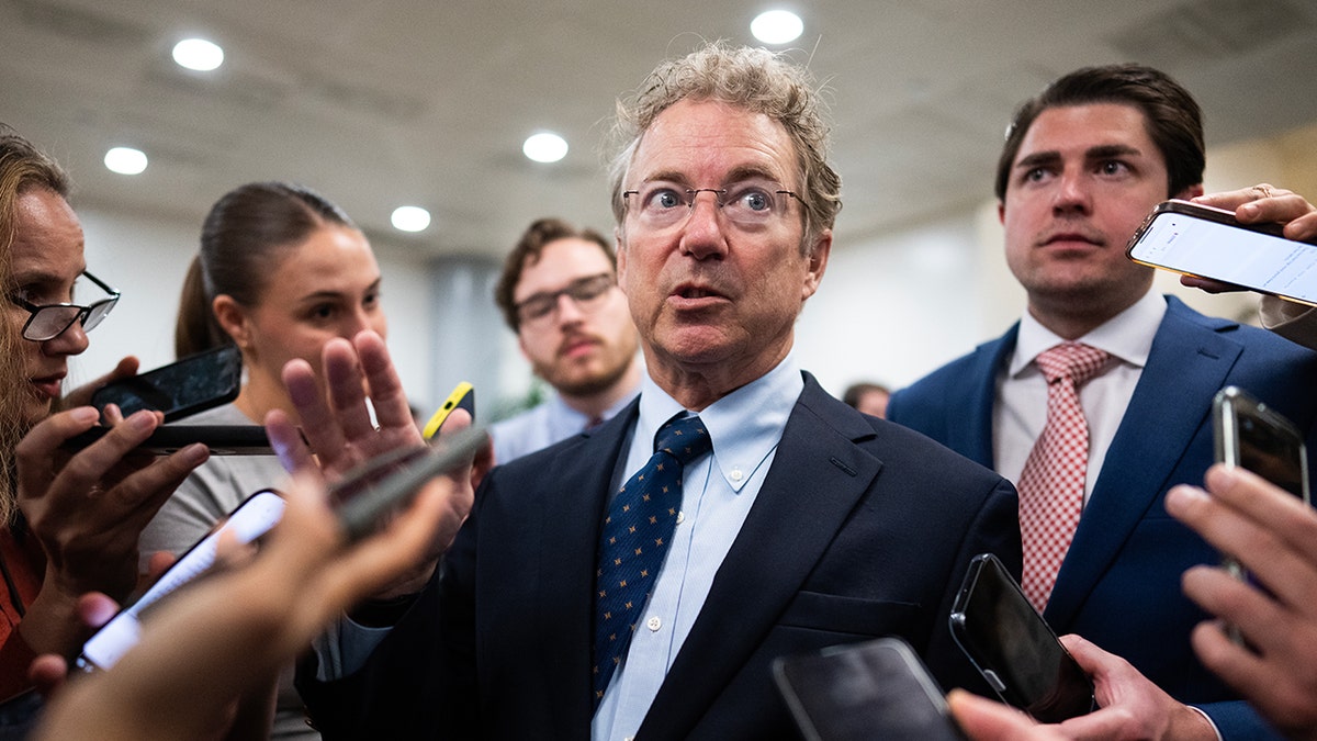 Rand Paul surrounded by reporters in May 2025