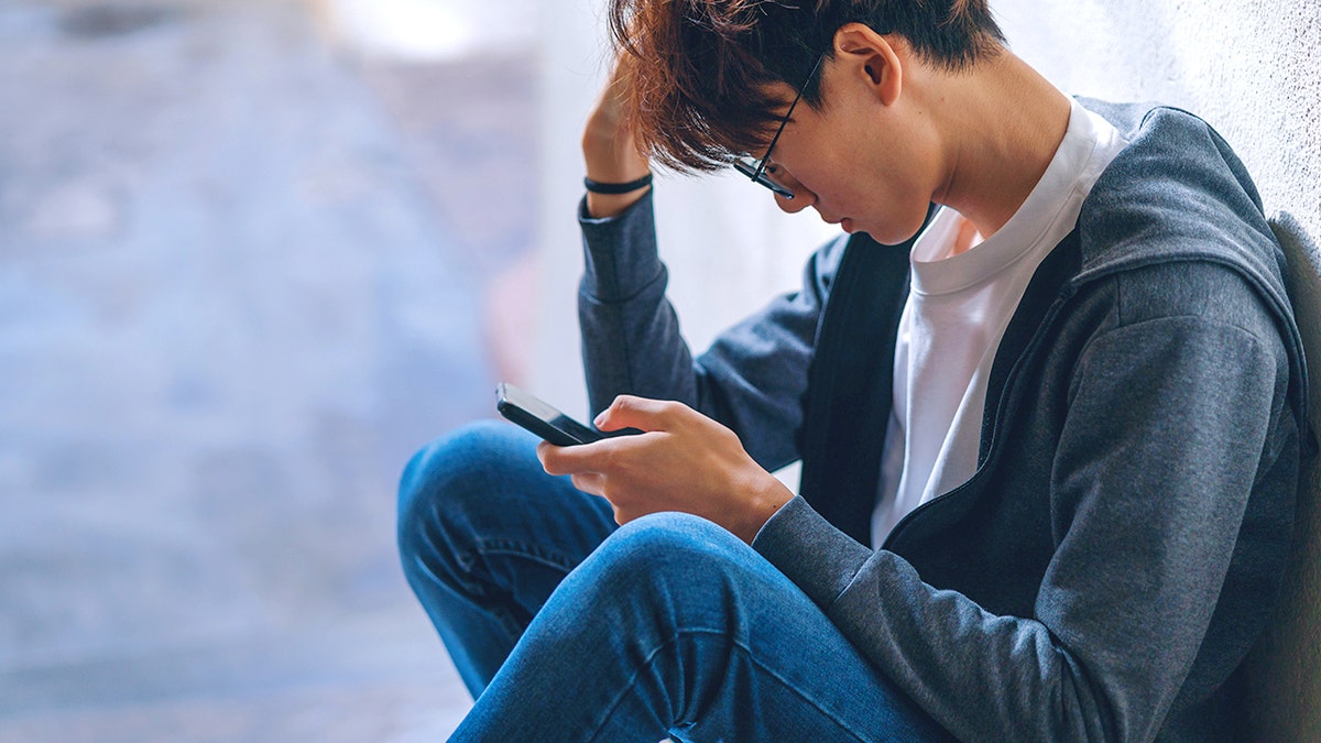 Teenage boy on smartphone