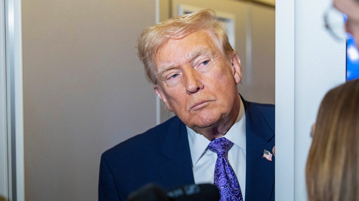 donald trump aboard AF1 during press gaggle with reporters