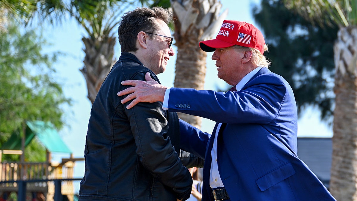 Elon Musk and Donald Trump embrace 