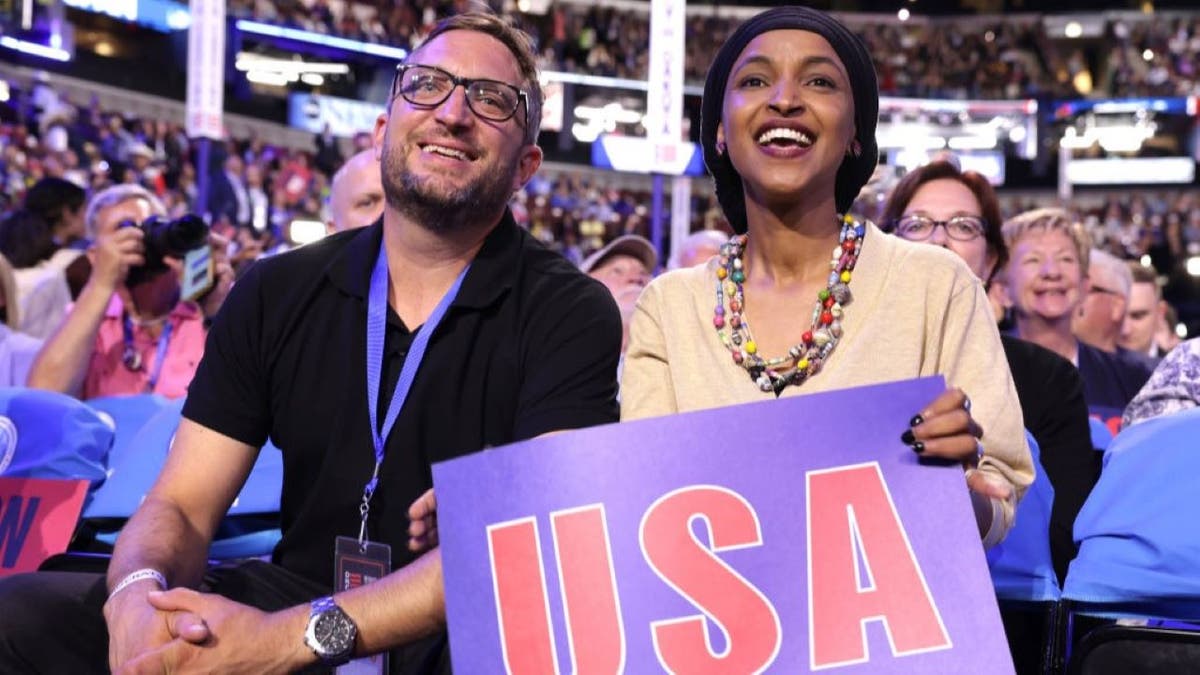 Ilhan Omar sits with husband Tim Mynett.