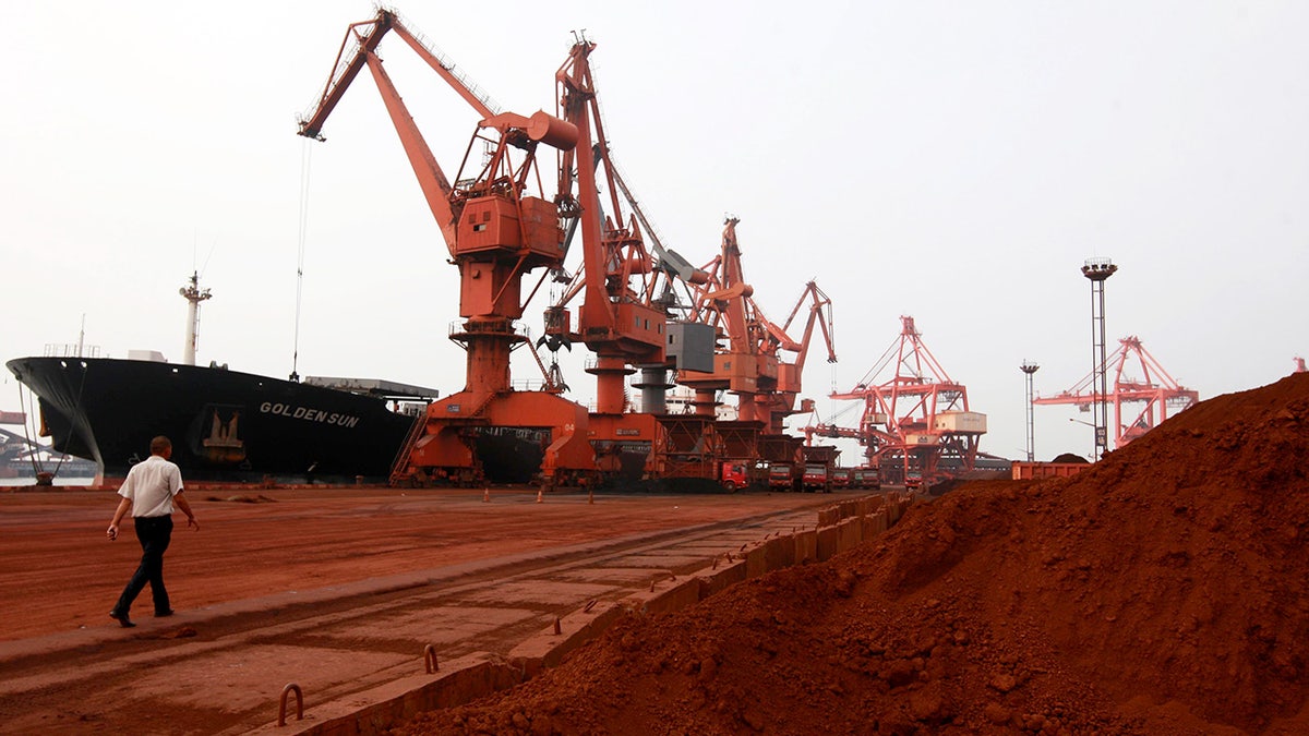 Bulldozers scoop soil with rare earth minerals in China