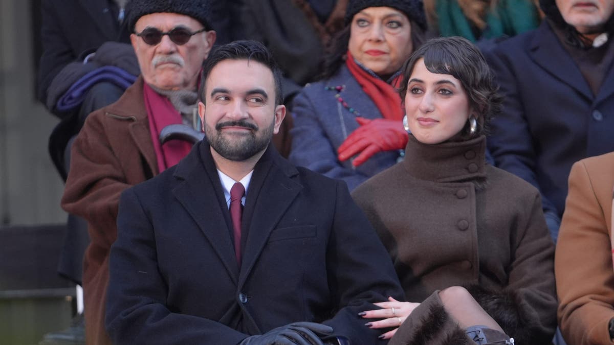 Mamdani seated with his wife at inauguration 