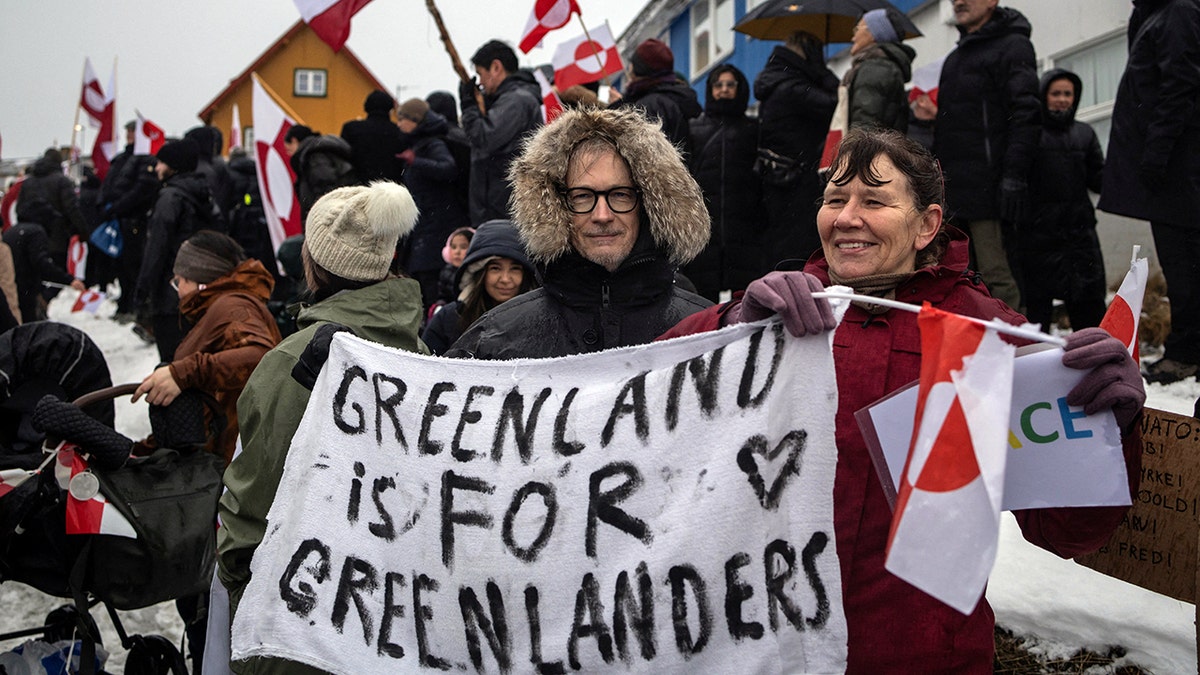 Greenland protester holds 'Greenland is for Greenlanders' sign.