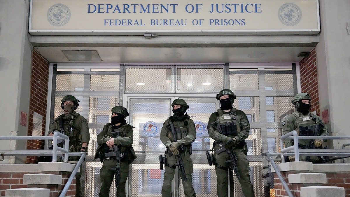 Law enforcement officers secure the perimeter of a city jail facility.