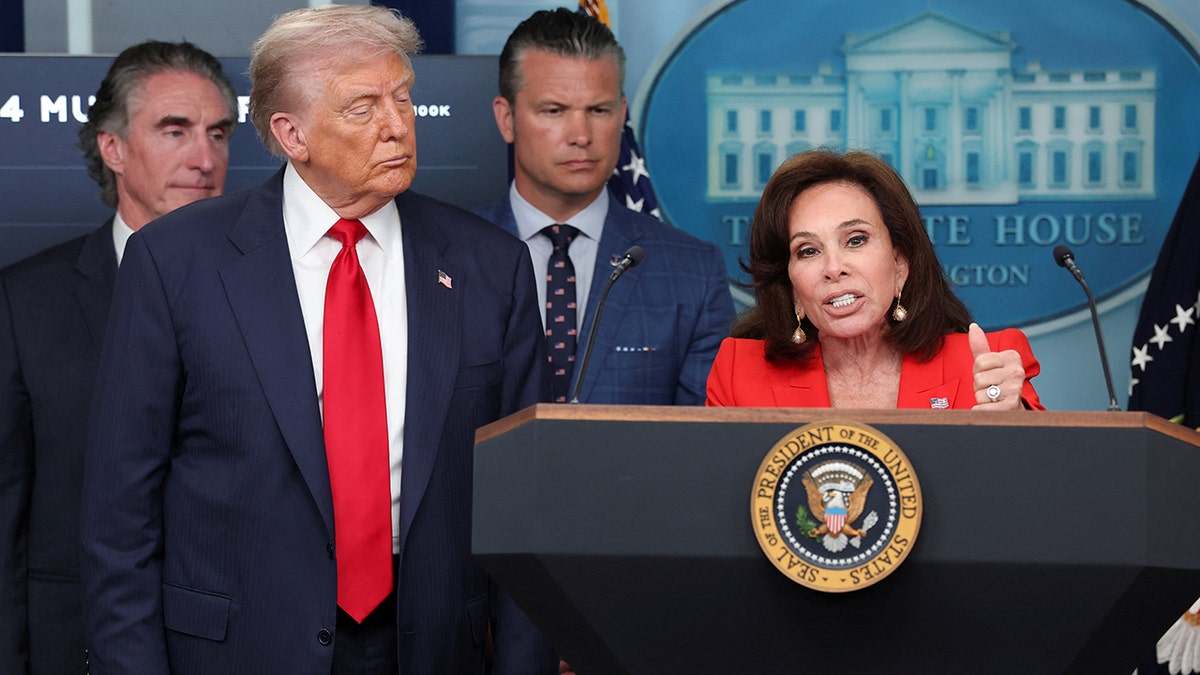 President Donald Trump looks on as U.S. Attorney for the District of Columbia Jeanine Ferris Pirro speaks at White House
