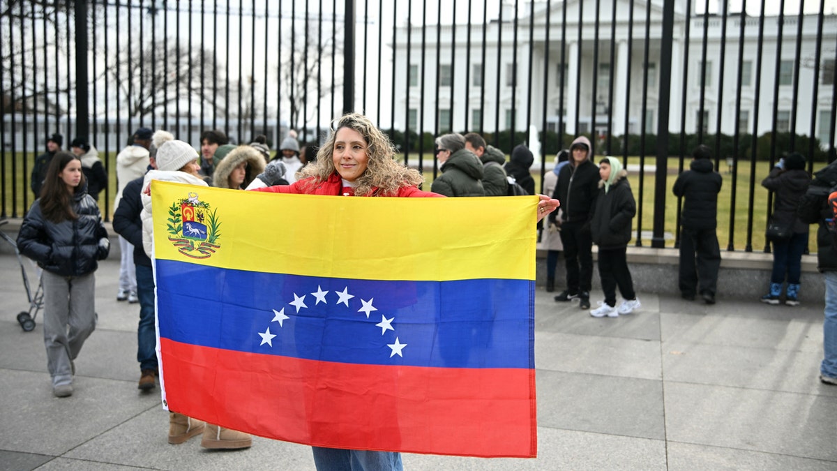 Venezuelan woman holds a flag in front of the White House