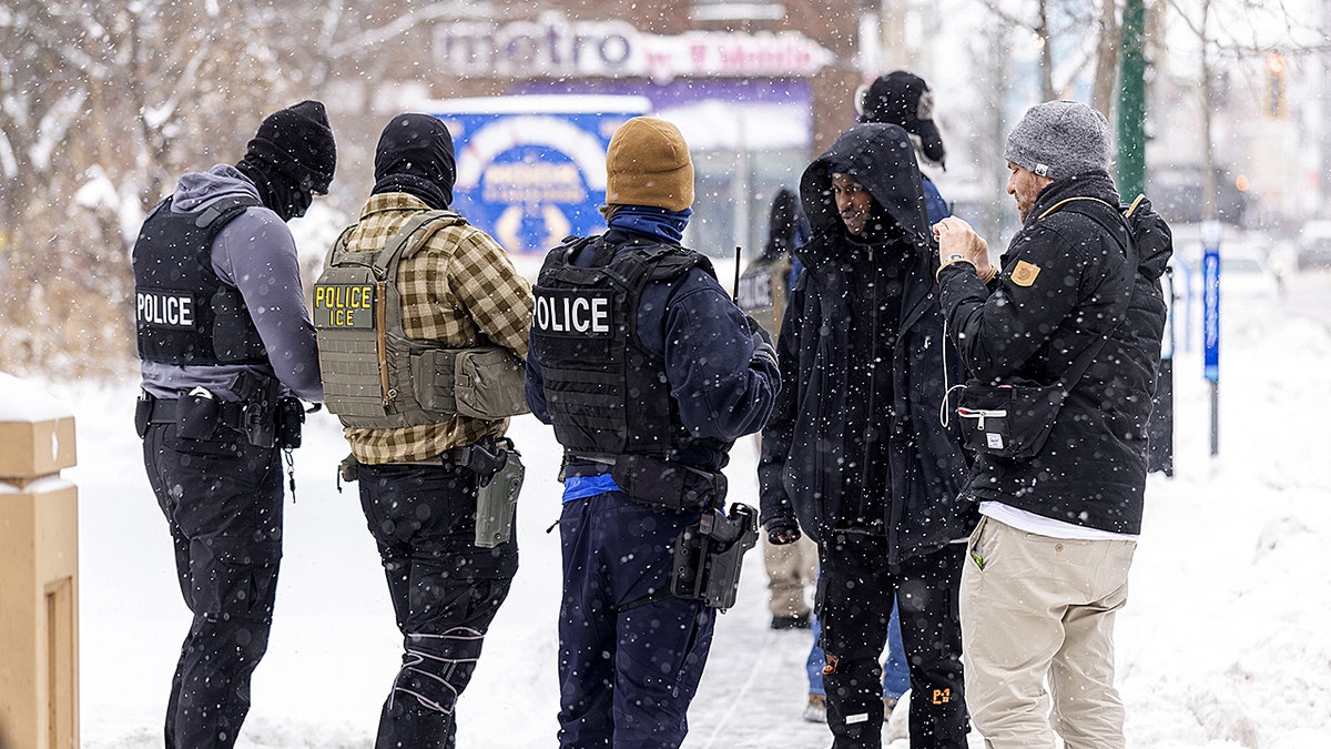 ICE agents stand outside in the cold in Minnesota.