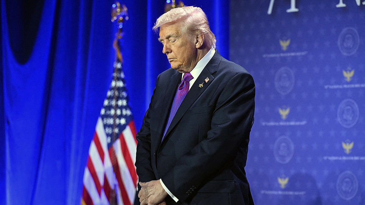 President Trump bows his head in prayer
