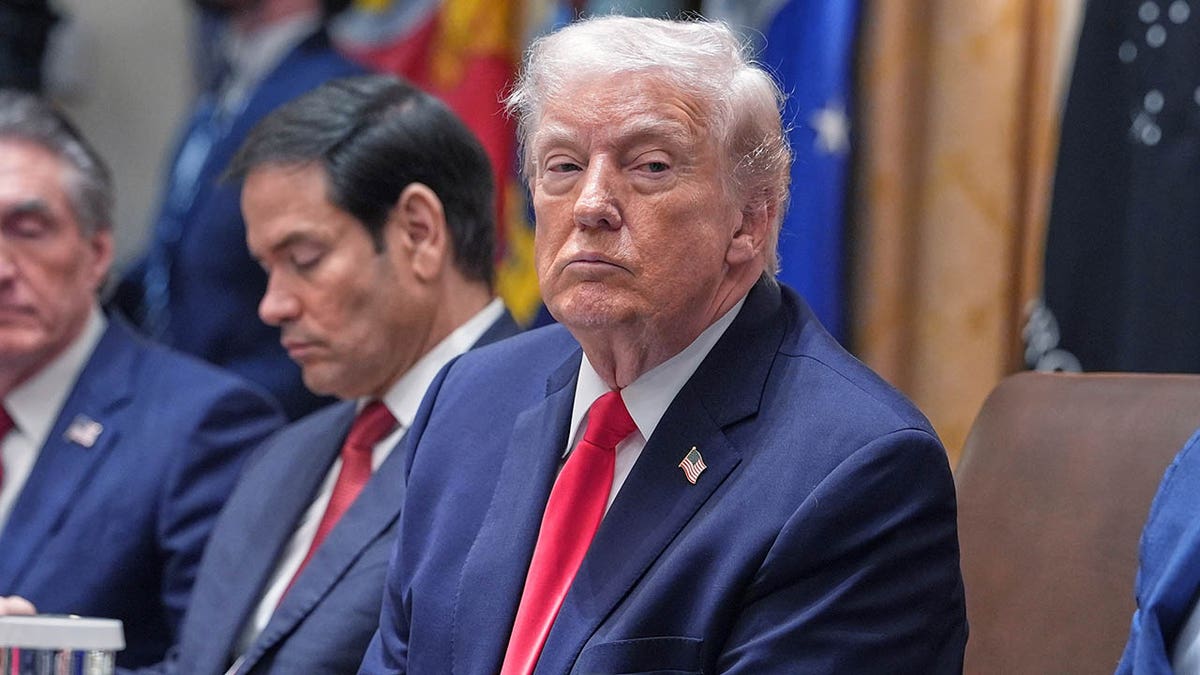 Trump listens in a meeting in January 2026