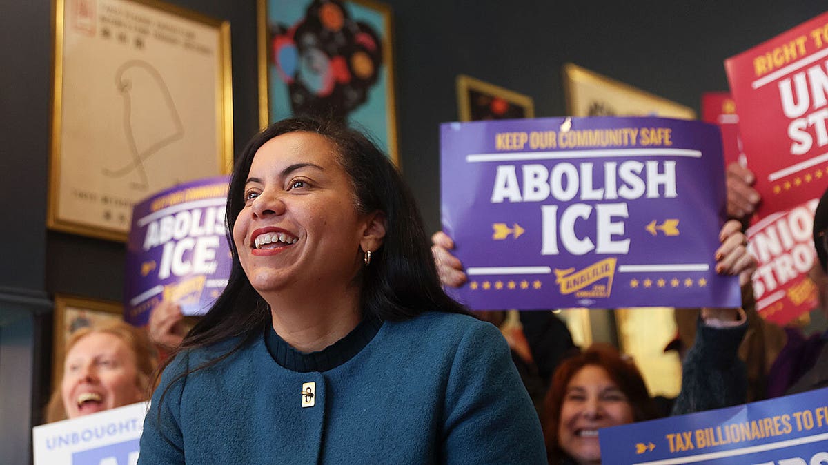 Analilia Mejia laughing with supporters rallying behind her.