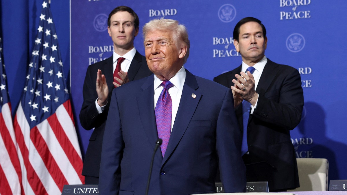 Donald Trump stands in front of Jared Kushner and Marco Rubio