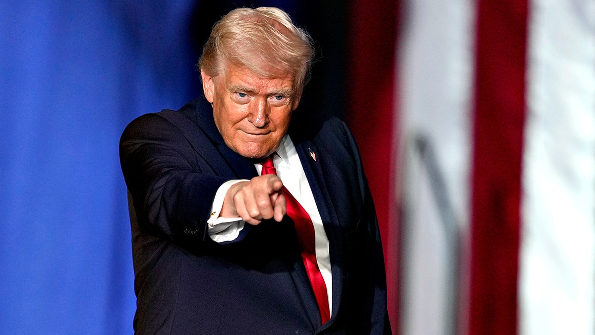 President Donald Trump pointing while on stage