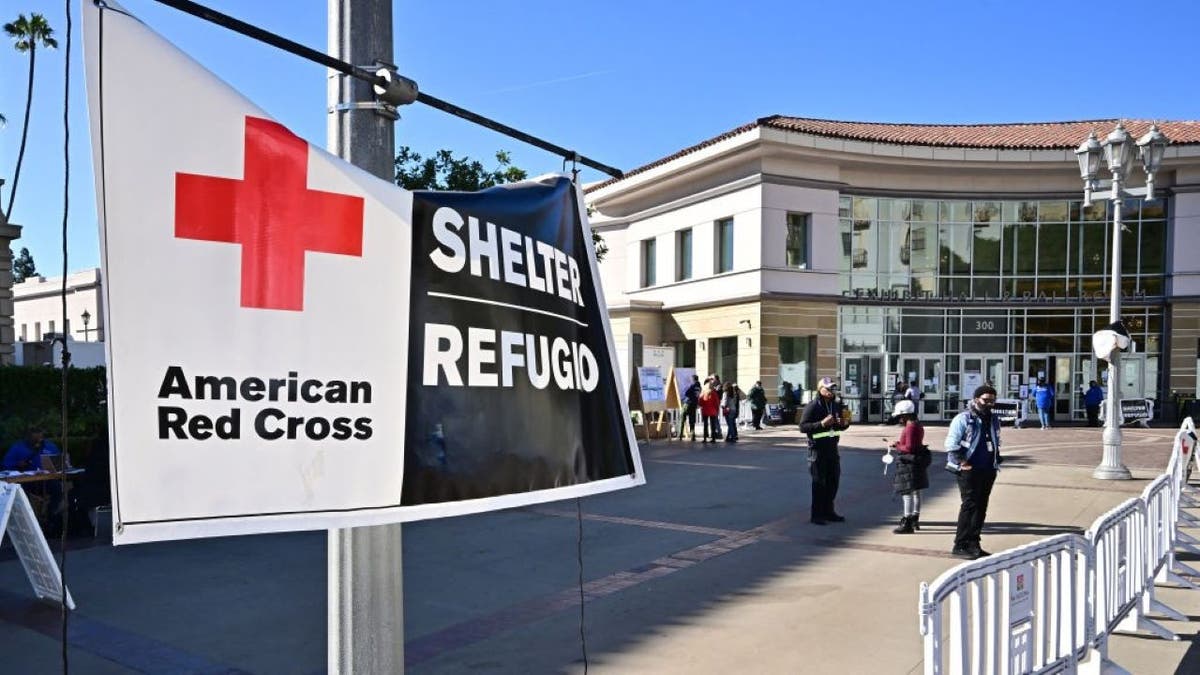 People are seen outside a wildfire shelter at the Pasadena Convention Center on January 21, 2025