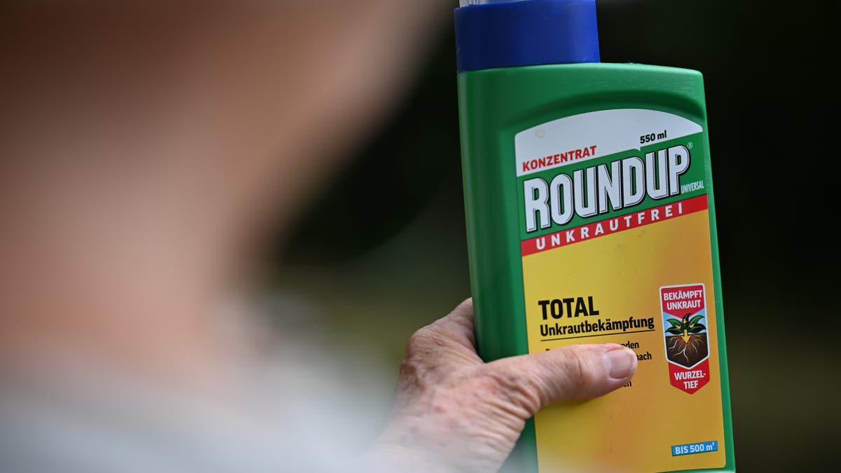 Gardener holds up pesticide